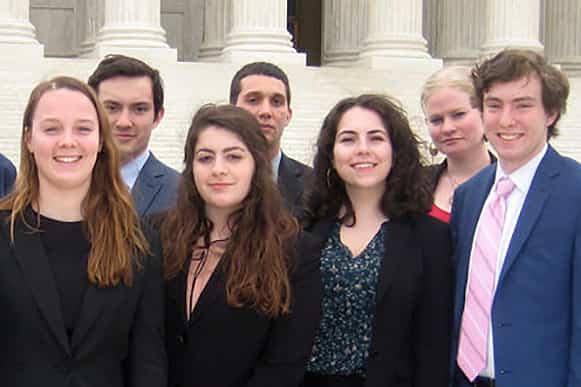Political Science students pose in front of a judicial building
