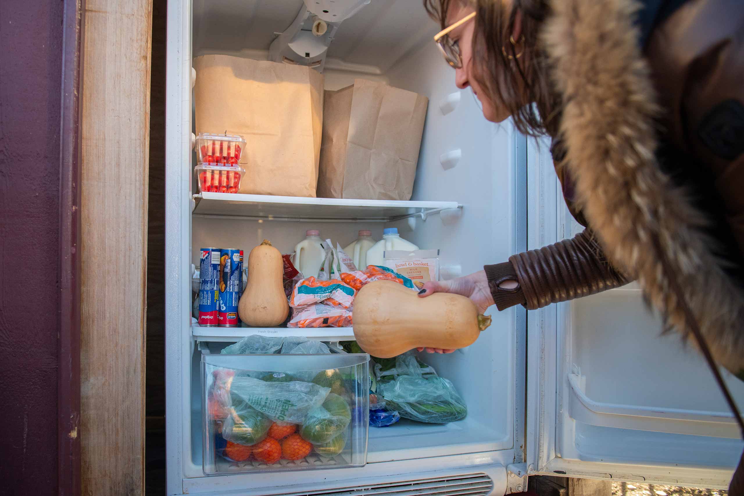 A student with Ƶ Hillel stocks a community fridge in Worcester.
