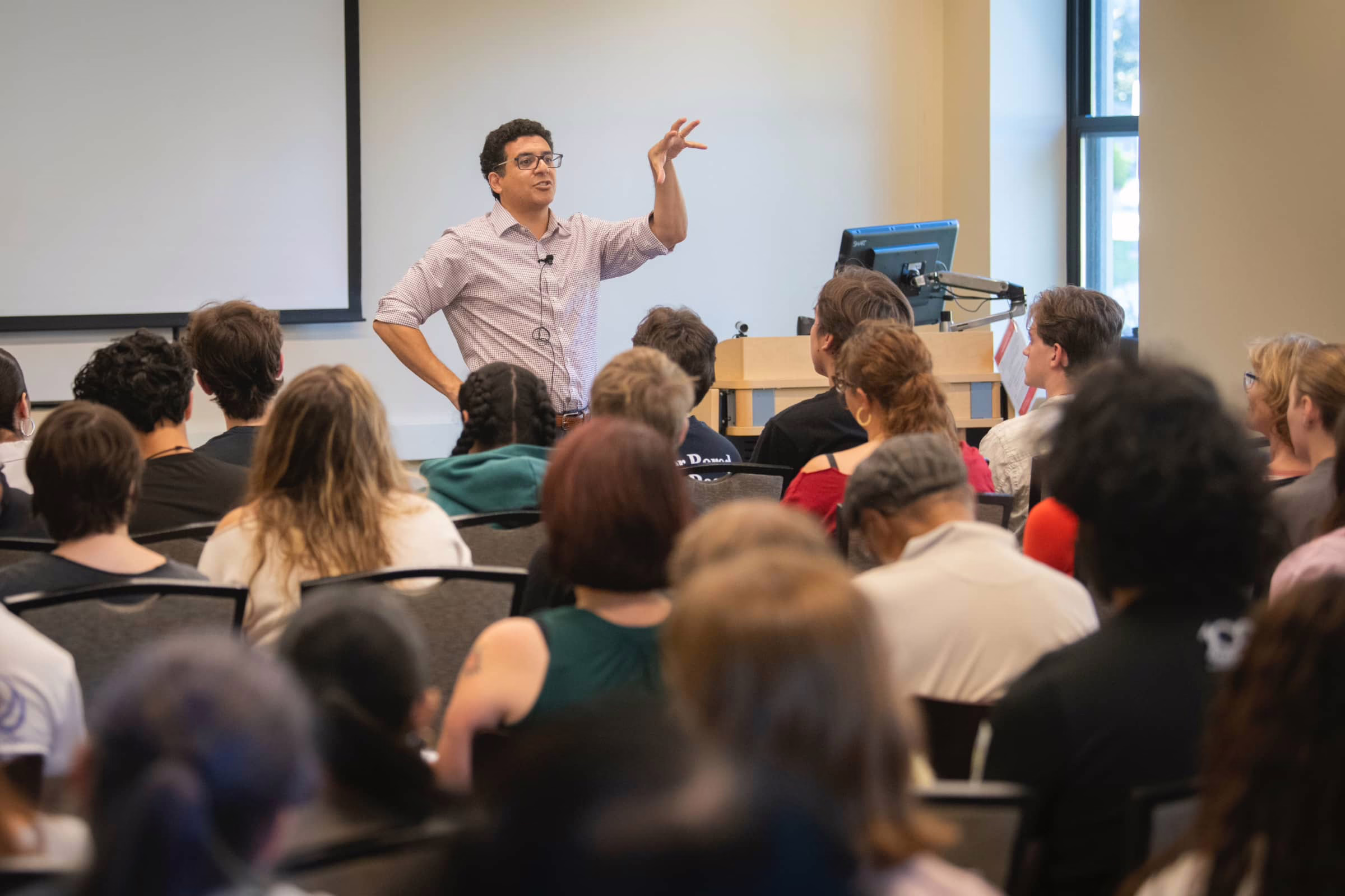 Aziz Rana delivers a guest lecture at Clark