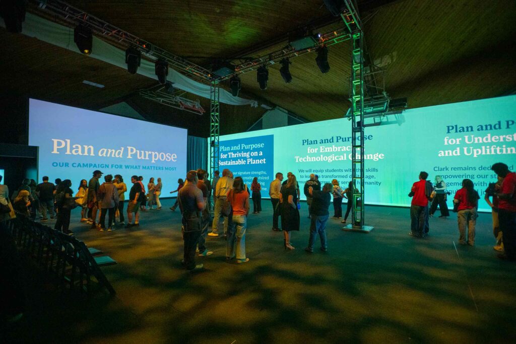 A gathering of alumni, trustees, faculty, administration and staff view the immersive installation at the kick-off event for the Plan and Purpose, campaign for what matters.