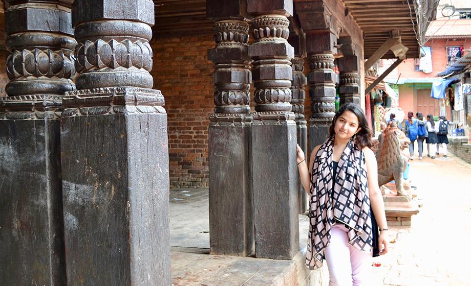 Sweta Basnet standing next to stone ruins