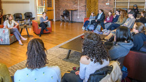 Students sitting around room discussing issues