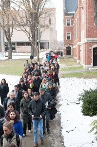 The "poetry stampede" from Razzo Hall to Jefferson 320 included the speaker himself: Richard Blanco is carrying books under his arm toward the front of the crowd.