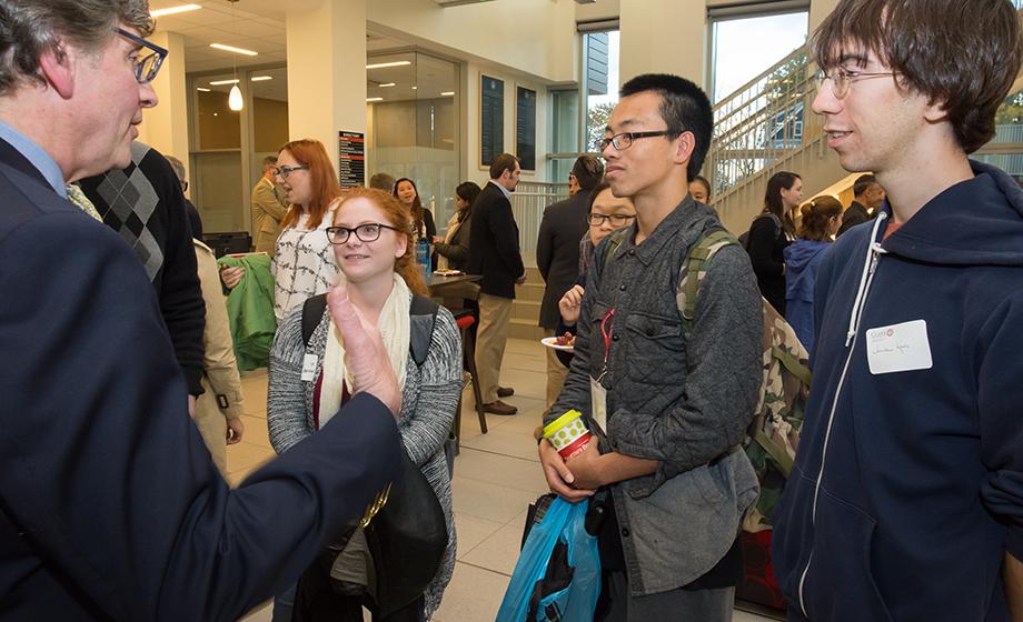 Alumnus Christopher Palatucci talks to three students