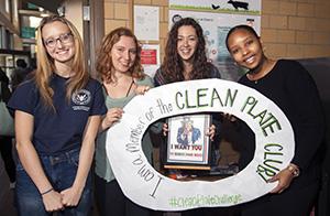 First-year students in President David Angel's "Challenge Convention. Change Our World" First-Year Intensive course with the plate outline used for photos during the social action.