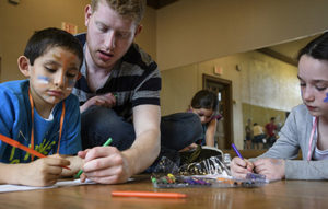 student teacher with children coloring