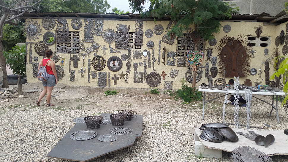 A student browses a craft village in Haiti