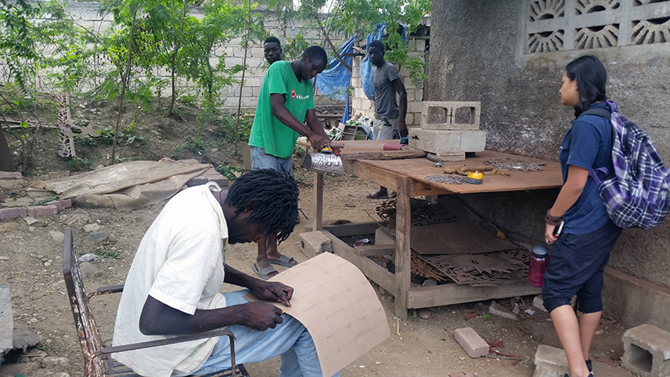 Artisans work in a craft village in Haiti