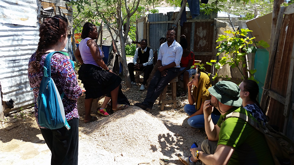 Fernando's students speak to residents of a refugee camp