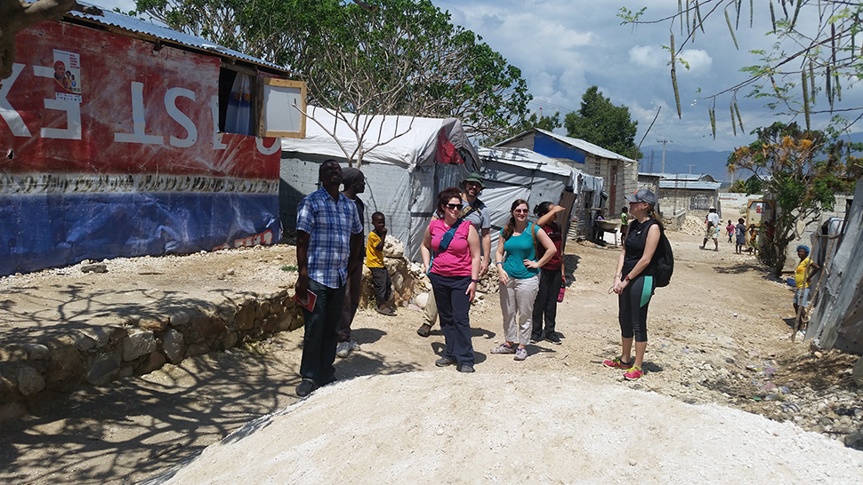 Jude Fernando's students walk through a refugee camp in Haiti