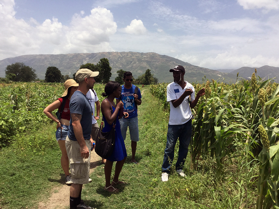 Jude Fernando's students listen during agricultural field work