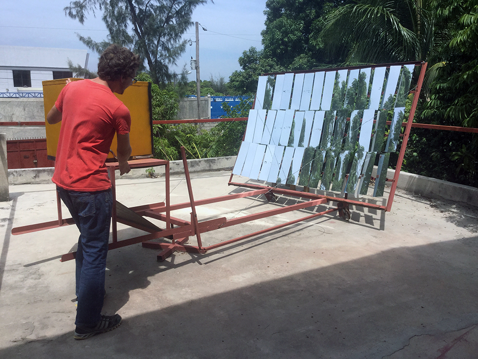 A student demonstrates solar panels in Haiti