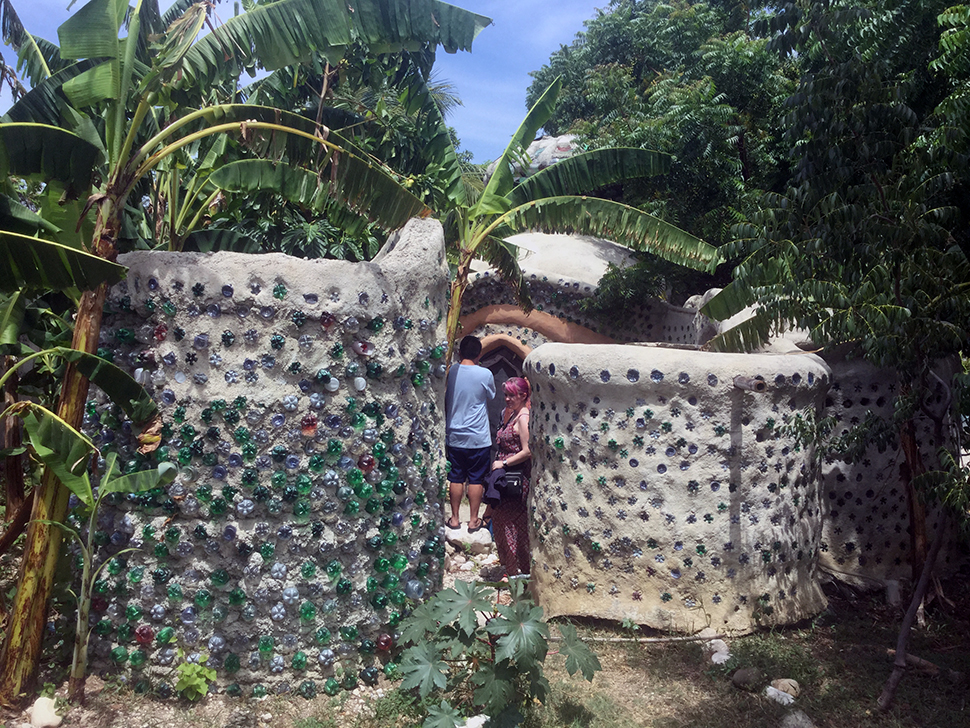 Students examine a superadobe structure in Haiti