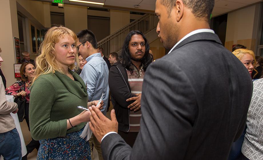 alumni members talking business in hall