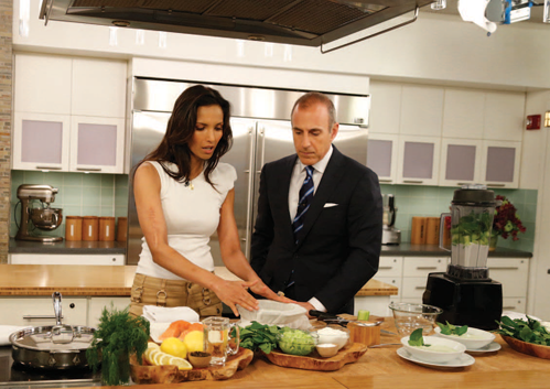 Lakshmi demonstrates a cooking technique to Matt Lauer