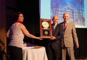 Scott Rechler '89 receives the gift of a clock from Director of Alumni Affairs Aixa Kidd and President David Angel.