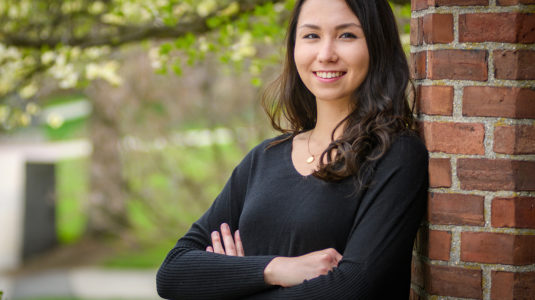 Rachael Chen standing, with arms crossed