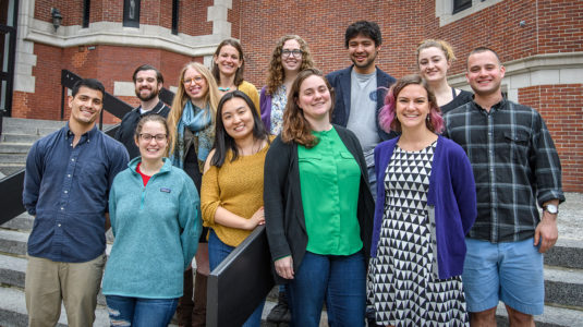 Students in GIS class stand outside on steps