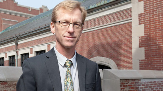 Tony Bebbington standing in front of geography building