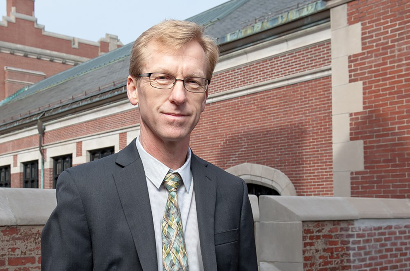 Tony Bebbington standing in front of geography building