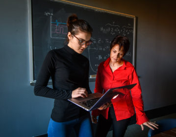 Liana Shpani holds a laptop as Barbara Sansone looks at the screen