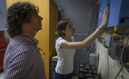 Megan McIntyre and Professor Chuck Agosta looking at instruments 