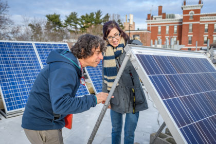 Chuck Agosta and Megan McIntyre looking at solar panels