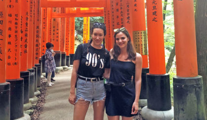 Tiffany Kayo and Christine Zymaris standing in Fushimi-Inari Taisha in Japan