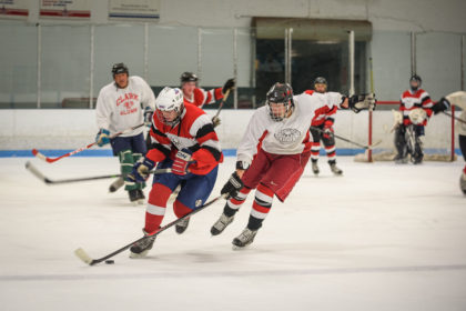 Clark alumni and current student-athletes skate in the annual alumni hockey game