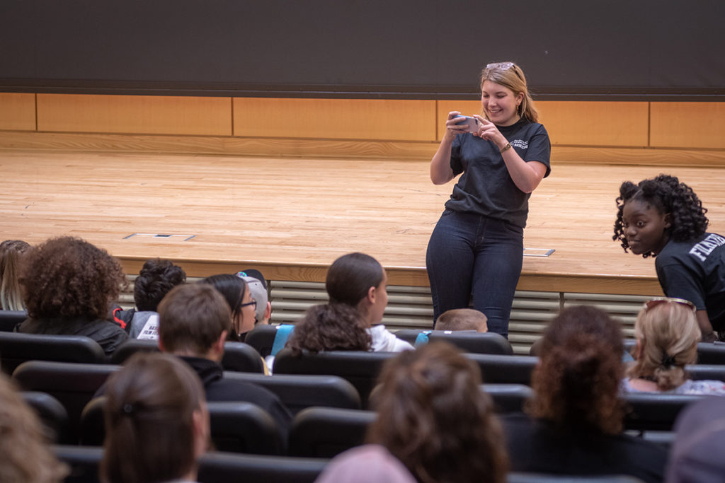 Gillian Rude snaps a photo of the audience.