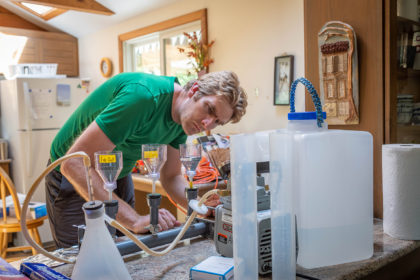 Nathan Ahlgren performs tests on water from Cape Cod kettle ponds