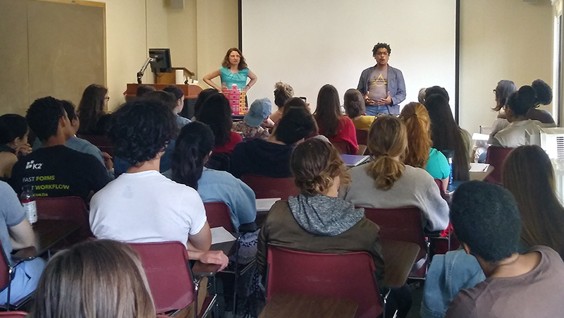 Dominican poet Leonardo Nin speaks before a crowded room of students during a classroom visit in Estabrook Hall.