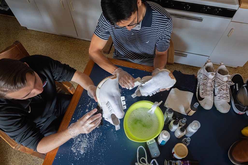 Trevor Tarnowski and Hector Miron Dominguez at work on cleaning shoes