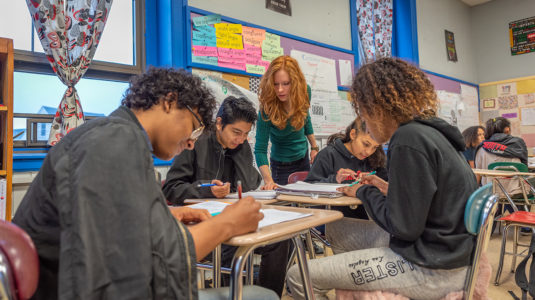 University Park Campus School students work with a teacher in the class