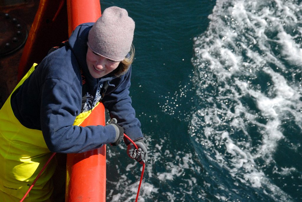 3)Karen Frey deploys instruments into the Bering Sea that measure the transmittance of light through seawater onboard the Canadian Coast Guard Ship Sir Wilfrid Laurier in July 2019