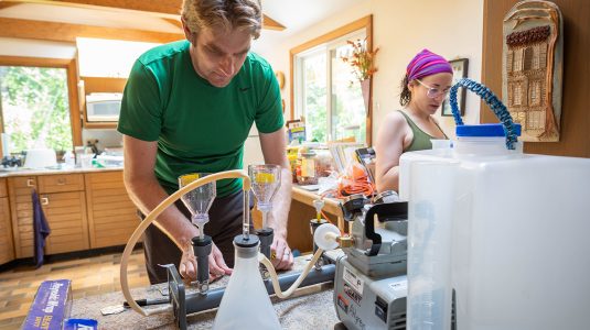 Nathan Alhgren and student conduct kettle pond research