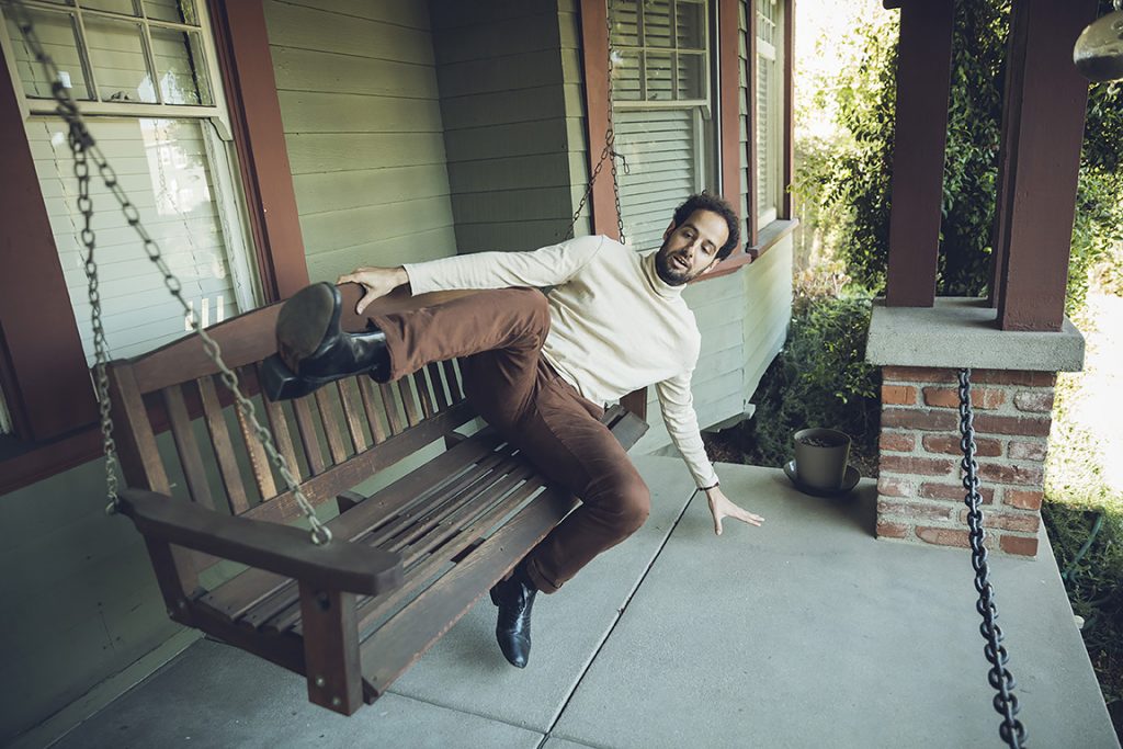 Charles Gould '07 lying on a porch swing