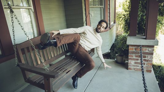 Charles Gould '07 lying on a porch swing