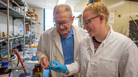 Katie Meehan '19 and Professor Mark Turnbull work in the chemistry lab