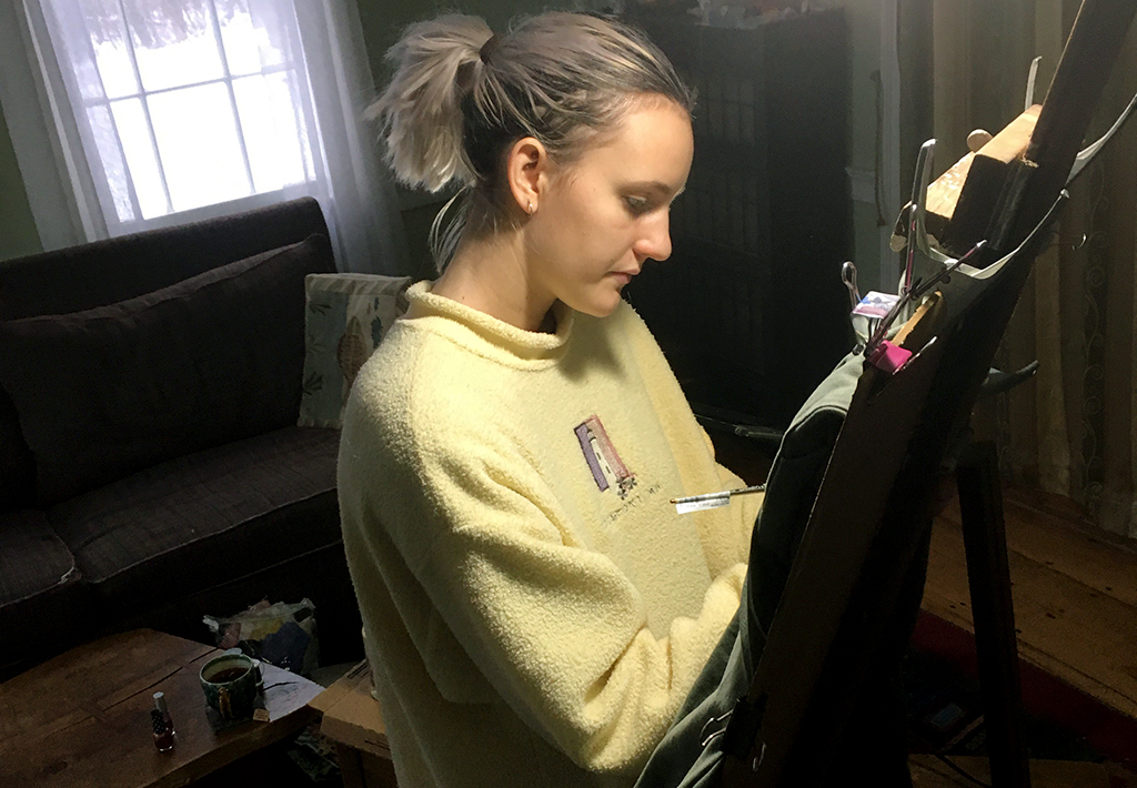 Lilah Feitner works on a piece of clothing from her collection