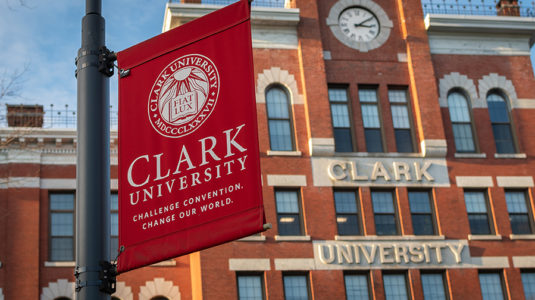 Jonas Clark Hall with Clark University banner in foreground