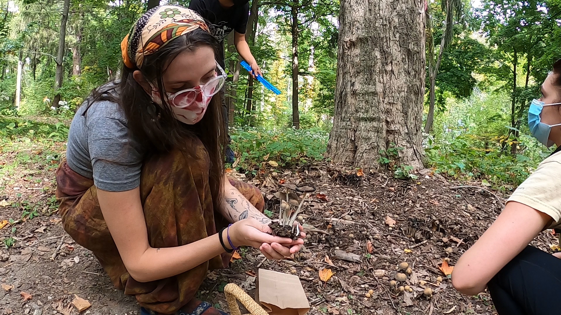 student holding mushrooms