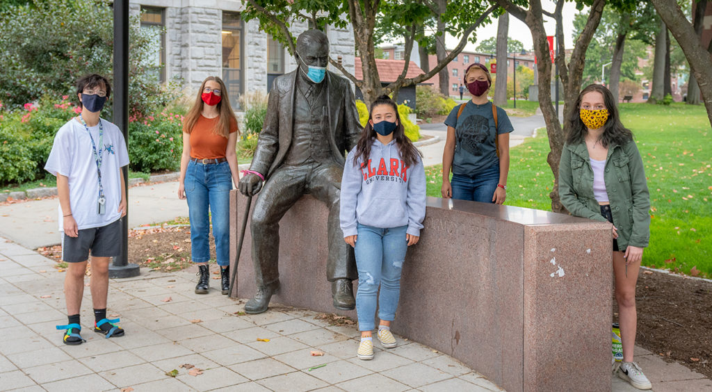 Students in "Pandemic: From Horror to Hope" course stand by the statue of Sigmund Freud on the Clark campus.