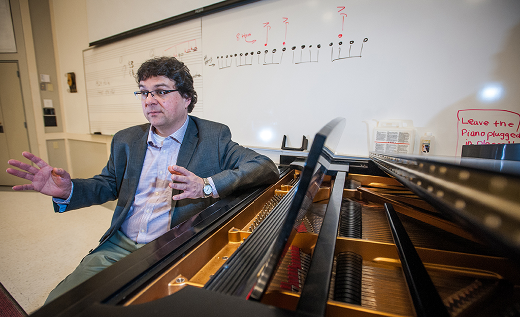 Professor Ben Korstvedt sits at the piano