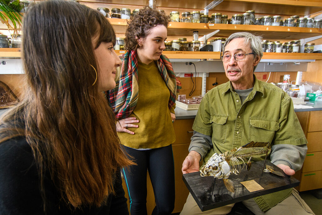 Professor John Baker works with students in 2018.