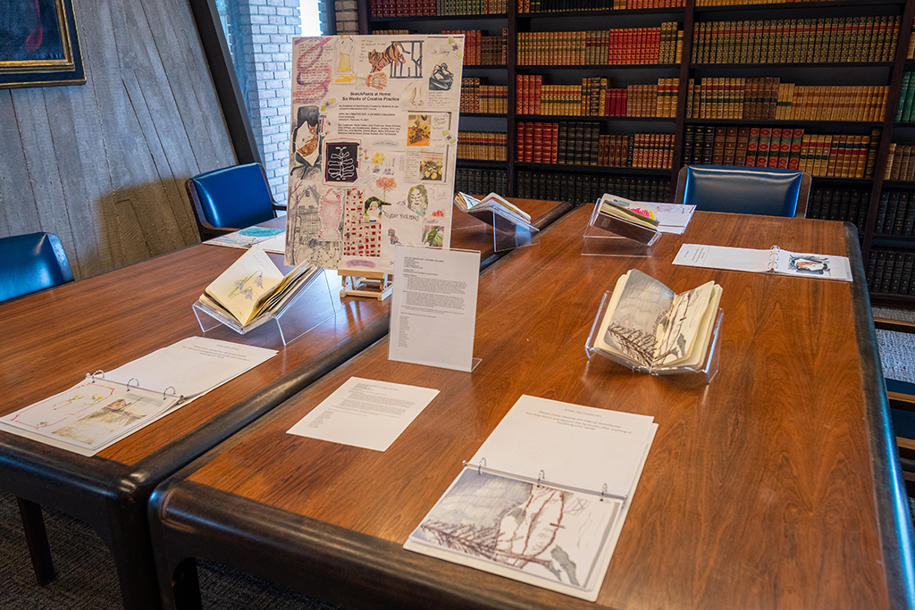 Sketchbooks by Clark University students on display in the Goddard Library Rare Book Room