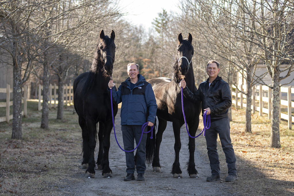 David Fithian and Michael Rodriguez with two of their Fresian horses