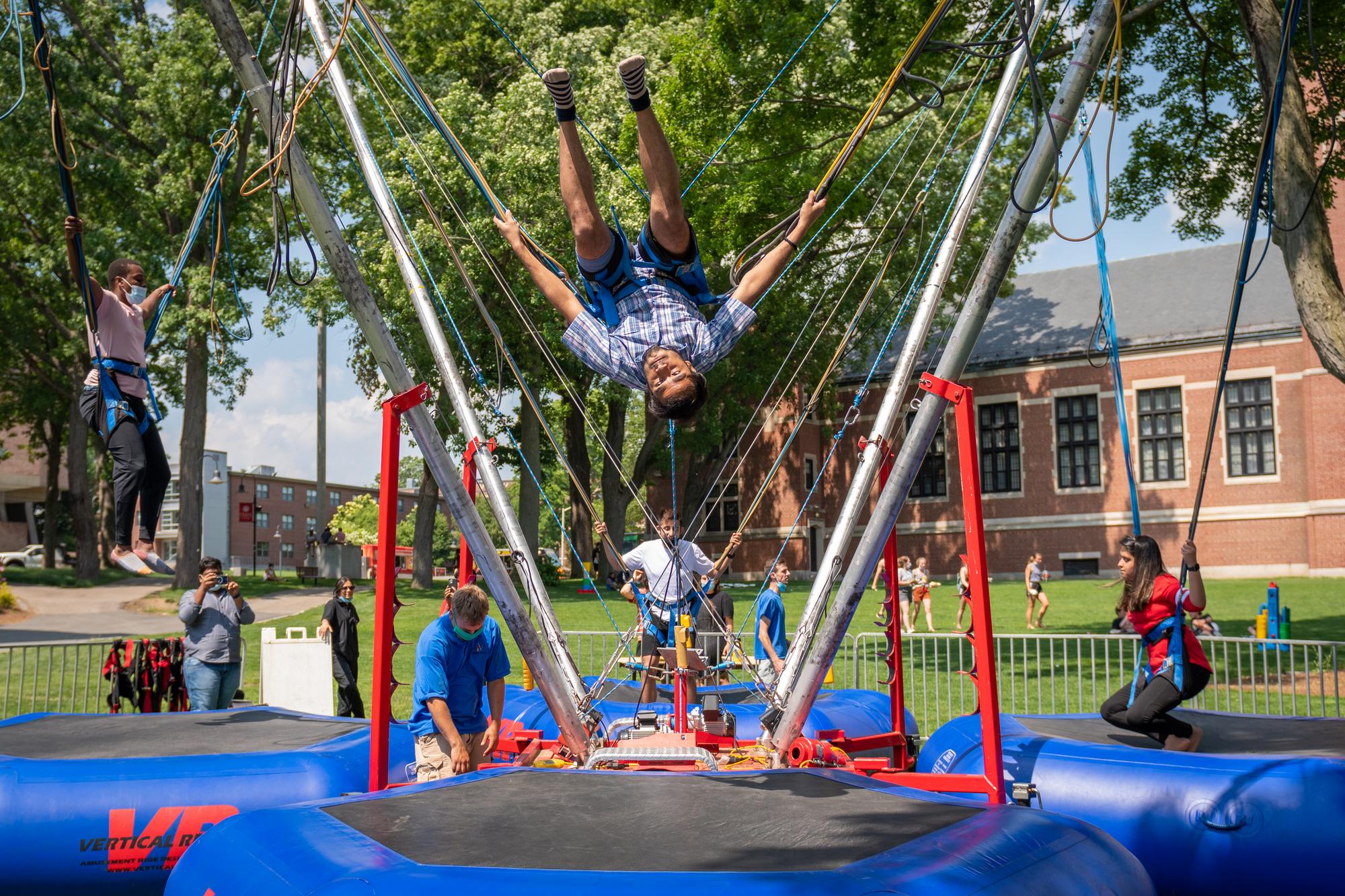 students jump on bungee trampolines