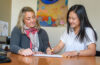 Jessica Bane Robert, director of prestigious fellowships and scholarships (left), works with a Clark student in her office.