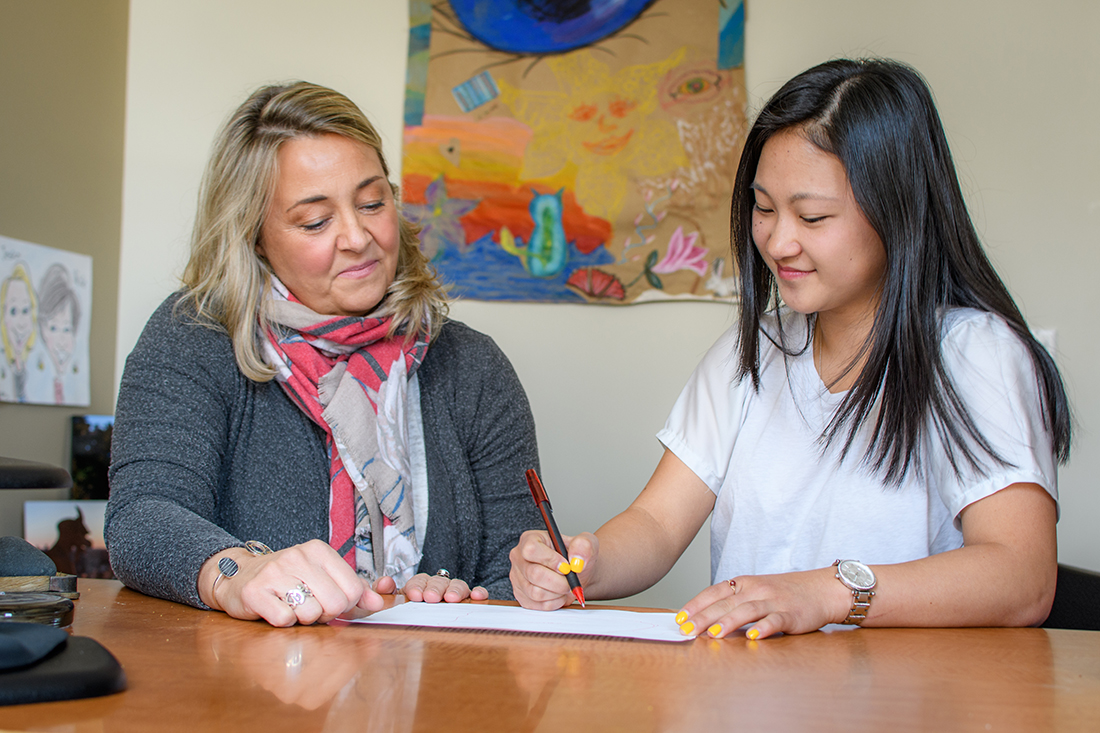 Jessica Bane Robert, director of prestigious fellowships and scholarships (left), works with a Clark student in her office.